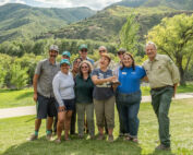 group of individuals standing and receiving an award